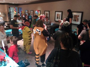 People in costumes standing in a room. 